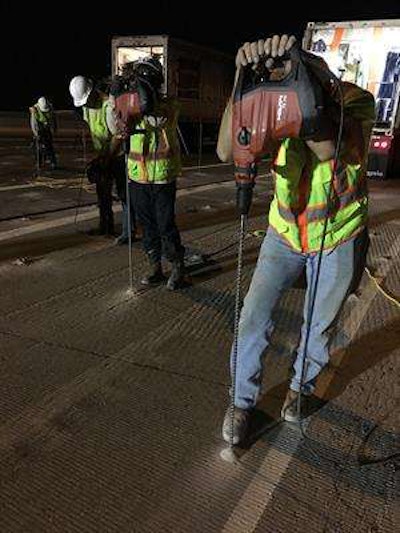 Workers drilling holes at foam injects sites.