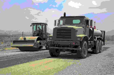 U.S. Navy Sailors from the Naval Mobile Construction Battalion 22 spray sand and gravel with water and compress it with a roller during a road construction project May 2 at Chebelley, Djibouti. The one-mile construction project took approximately two months to complete. (U.S. Air Force photo by Staff Sgt. Eric Summers Jr.)