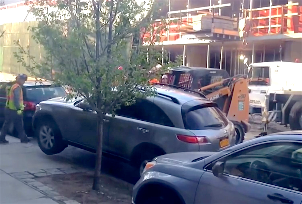Skid steer lifting car NYC