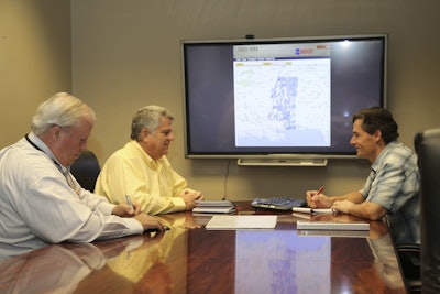 Doug Hornback of MDOT’s Maintenance Division and Don Grayson and David Brown of MDOT’s Information Systems Division work on MDOT’s outdoor advertising control system. (Mississippi DOT)