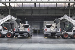 Skid-Steer loaders drop approximately 825 pounds of landscaping blocks into the beds of a 2016 Chevrolet Silverado and a 2016 Ford F-150 (from left to right).