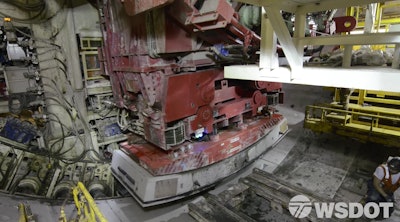 While Bertha’s cutter head digs deep below Seattle, her rear end places giant pieces of concrete to form the circular frame of the tunnel.