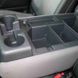 The fold-down armrest in the 2017 Titan XD Standard Cab offers two more drink holders for a total of eight. Also, notice the removable dividers inside the storage compartment. Nice!