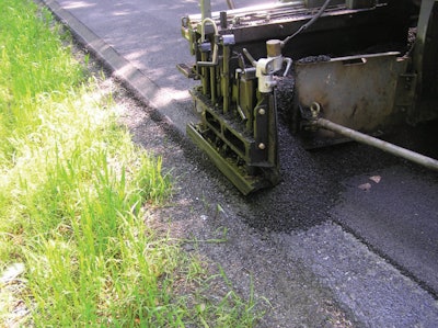 A wedge-shaped shoe acting as a screed attachment forms what is known as a Safety Edge, a 30-degree bevel that makes it easier for vehicles to return to the roadway in the event of an accident. Photo credit: FHWA