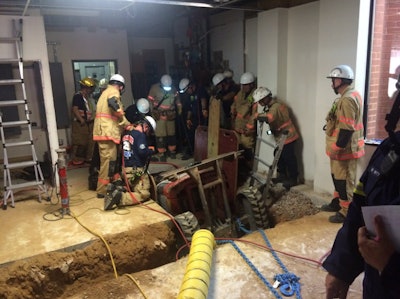 Montgomery County Fire & Rescue crews work to free a construction worker trapped inside a trench by a mini excavator. Photo Credit: Pete Piringer/@mcfrsPIO on Twitter
