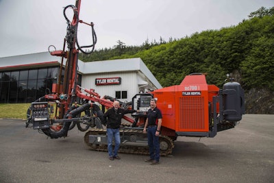 Tyler Rental’s Randy Johnson and Charlie Allen with a Sandvik DC700 surface top hammer crawler drill rig.
