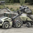 Volvo CE’s LX1 loader delivers a payload to the HX1, an autonomous hauler. Both machines were unveiled at the company’s Xploration Forum.