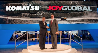 Komatsu president and CEO Tetsuji Ohashi, left, met with Joy Global president and CEO Ted Doheny, right, during the MINExpo show in Las Vegas in September 2016.
