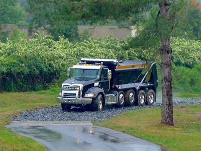 A 70,000-pound load buries our Mack Granite almost up to the rims in loose gravel, yet the AMT pulled through it with hesitation.