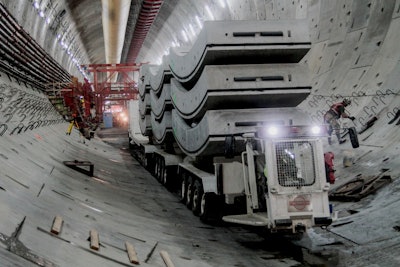A truck carries 10 tunnel liner segments into the SR 99 tunnel. The segments weight 360,000 pounds and will add up to one complete ring of tunnel lining. Photo credit: WSDOT via Flickr