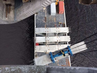 (Minnesota DOT) Using a segment lifter, crews place the final four bridge deck segments at Pier 11.