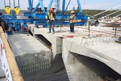 (Minnesota DOT) Crews guide one of the final segments into place at Pier 11.