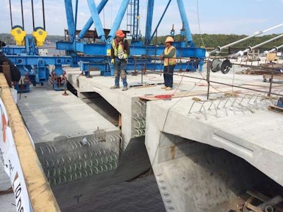 (Minnesota DOT) Crews guide one of the final segments into place at Pier 11.