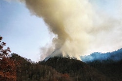 A photo from Nov. 27 shows smoke atop Chimney Tops, the mountain in Great Smoky Mountains National Park where the recent Gatlinburg/Pigeon Forge wildfire originated. Photo credit: Wayne Grayson