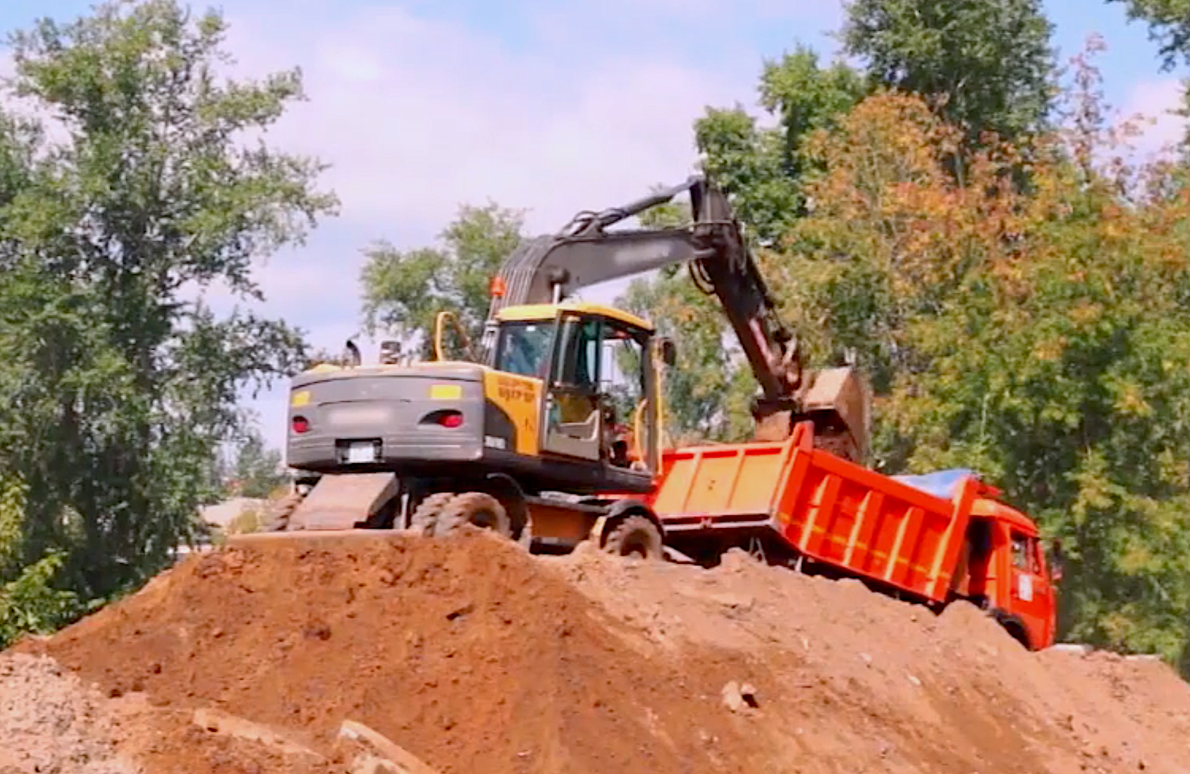 excavator-loading-truck-stock