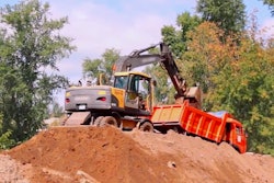 excavator-loading-truck-stock