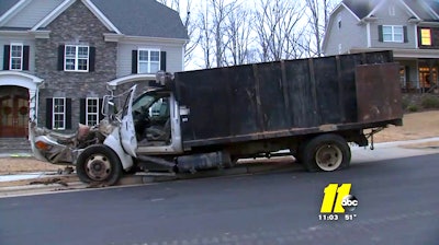 The badly damaged dump truck is seen after being removed from the home it hit in this still from ABC 11 WTVD footage.