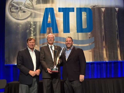 Dennis Slagle, president of Mack Trucks (left), and Jonathan Randall, senior vice president of sales for Mack Trucks North America (right), congratulate Robert W. Nuss, president of Nuss Truck Group (center), for being honored as the 2017 American Truck Dealers Truck Dealer of the Year.
