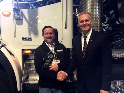 Bill Kozek, right, president of Navistar truck and parts, congratulates Robert Feldman on being named 2017 HX Series Walk-Around Competition champion.
