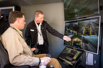 Cat expert equipment operator Brad Van De Ver explains how the Remote Operator system works to a media member. Photo credit: Wayne Grayson