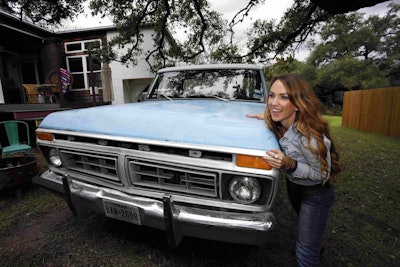 Kim Lewis of “Extreme Makeover: Home Edition” stands beside her 1977 Ford F-150 Ranger.
