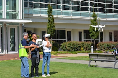 Javier Irizarry, far left, instructs as a student flies a DJI Phantom drone while another reacts to a first person perspective to the drone’s camera footage through virtual reality goggles. Photo: Ga. Tech