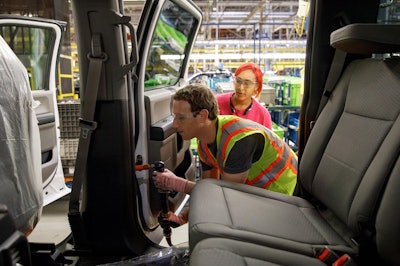 Facebook CEO Mark Zuckerberg helps to assemble an F-150 at the Ford Rouge Plant Thursday.