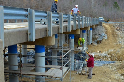 Members of the U.S. Army Corps of Engineers and graduate researchers from West Virginia University conduct repairs on the East Fork Bridge in East Lynn, West Virginia, March 27, 2014. The two entities partnered on the research and development of new applications of composite materials in civil works project rehabilitations including East Fork Bridge. Photo credit: U.S. Army