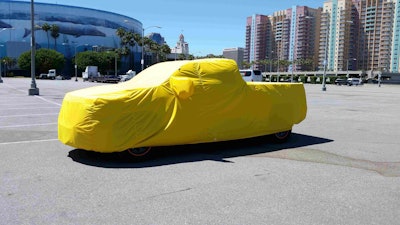 Almost ready…the Workhorse W-15 electric pickup sits under wraps in the parking lot of the Long Beach Convention Center Monday. The reveal is scheduled for Tuesday night.