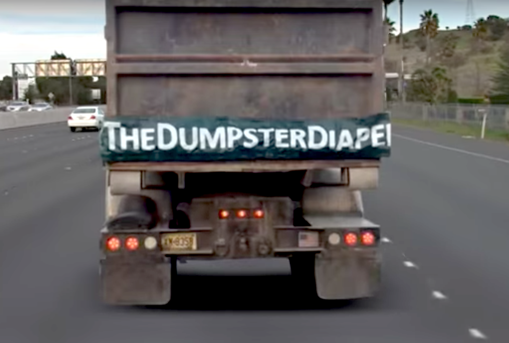 Dump truck diaper covers tailgate gap, prevents debris damage