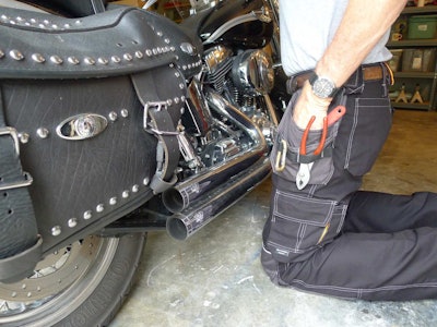 The side pockets and loops hold long handled tools like socket wrenches and hammers.