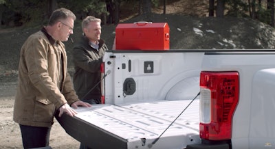 It’s back…Chevy Chief Engineer Eric Stanczak stands next to Chevy spokesman and retired NFL great Howie Long as he prepares to perform a puncture test on the aluminum bed of a 2017 Ford F-350 Super Duty pickup.