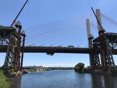 A view of the new Kosciuszko Bridge after the main span of the old Kosciuszko Bridge had been lowered and floated out to the East River, from where the main span was to be taken to a recycling facility at Jersey City. (Skanska USA)