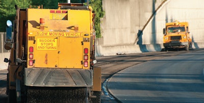 This sweeper truck is cleaning up materials before new asphalt is placed on a roadway in Oregon.