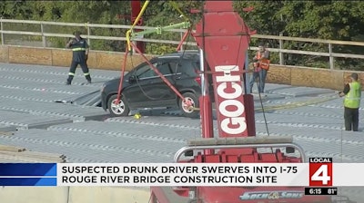 Screenshot of crews removing the vehicle from the bridge construction site. Click On Detroit.