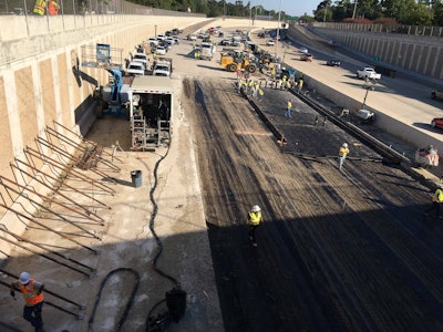 Road crews repair the southbound lanes of the Sam Houston Tollway, a section covered by an estimated 70 million gallons of water from the rain-swollen Buffalo Bayou. At left, crews had to first brace the retaining wall, which backed up to a large sinkhole, to make the work area safe. Source: TxDOT