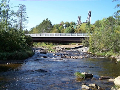The 1980 Olympic ski jumps form an eye-catching backdrop for the new bridge on Route 73 south of Lake Placid, New York. The state is gearing up for more bridge projects, thanks to an additional $250 million in funding for municipalities. Photo by NYSDOT