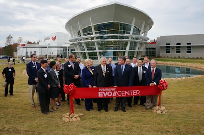 Georgia Governor Nathan Deal, center with yellow tie, prepares to cut the ribbon on Yanmar’s new Evo Center in Acworth. He is joined, on the right, by Yanmar America President Tim Fernandez and by first lady Sandra Deal, on the left. Photo by Don McLoud