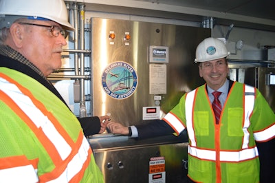 DRBA Commissioner Doug VanSant (left) of Bridgeton, New Jersey, and DRBA Commissioner Michael Ratchford of New Castle, Delaware, activate the new bridge dehumidification system on the Delaware-bound span. Photo: Delaware River and Bay Authority