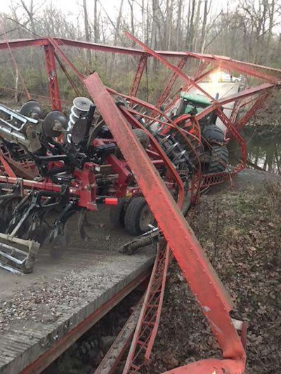 A tractor pulling a ripper that was too wide for the bridge tears down historic span in Boone County, Indiana.
