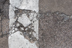 Stock road damaged crumbled crumbling asphalt