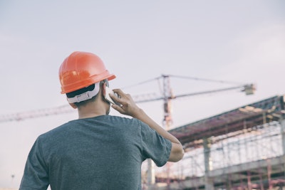 stock worker on smartphone phone cell phone tech