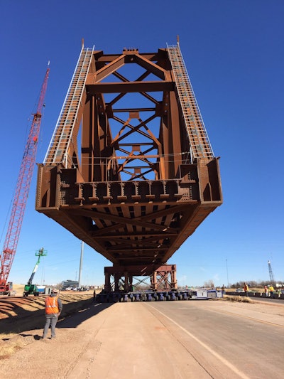 One of the two structures of the railroad bridge inches its way down I-235 for its installation. Photo: ODOT
