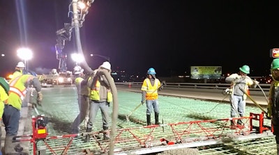 Crews pour cement for deck of City Center Drive bridge for the New Pueblo Freeway.