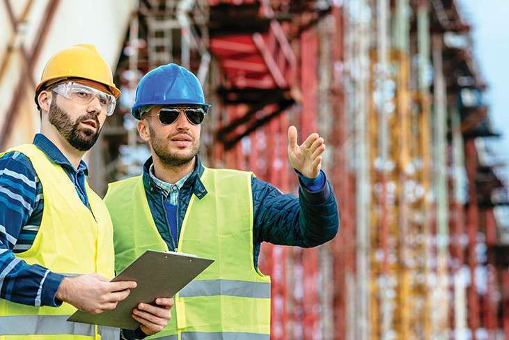 Workers talking construction jobsite stock