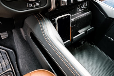 The smartphone holder can hold three phones securely thanks to a nice clamp at the bottom, and will wirelessly charge your devices. Photo: Wayne Grayson