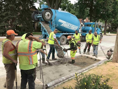 In Minneapolis, crews work to improve streets by using a progressive concrete preservation strategy. Above, workers carry out a full panel pour. Photos: International Grooving & Grinding Association.