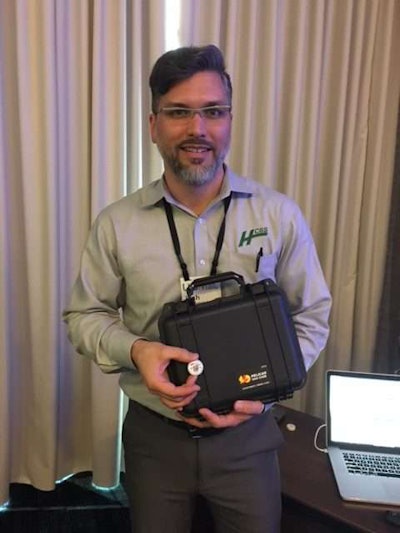 Josh McDonald, HCSS R&D product manager, shows the iBeacon transmitter.