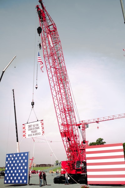 Manitowoc crawler crane MCL100-1 holding up its unveiling sign