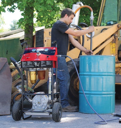 A man using the IPA Tools' Pneumatic Fuel Tank Sweeper on a blue barrel